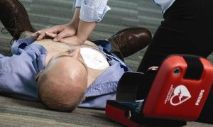 A caregiver defibrillates the victim with the Philips HeartStart FRx defibrillator